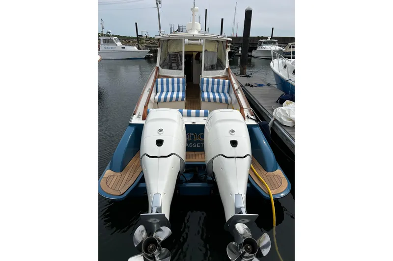 Slide: The Image of Hinckley 35 boat, 2022 model, docked with twin outboard engines and striped seating. - 7