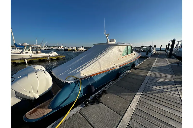 Slide: The Image of Hinckley 35 yacht, 2022 model, docked at marina under clear blue sky. - 9