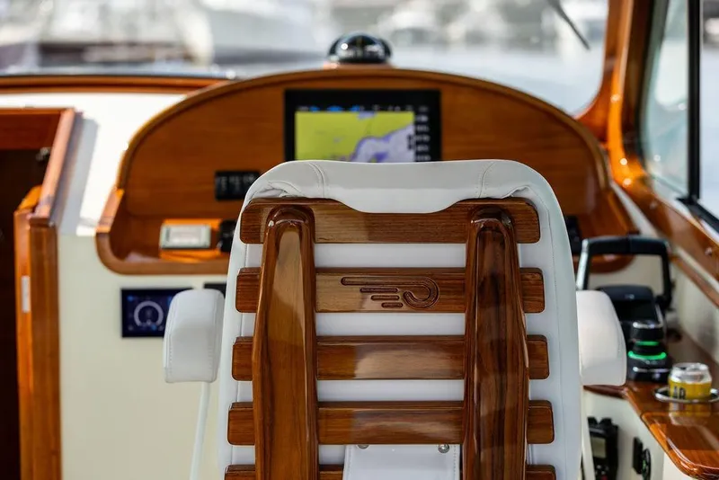 Slide: The Image of Helm of 2022 Hinckley 35 yacht with wooden accents and navigation display. - 14