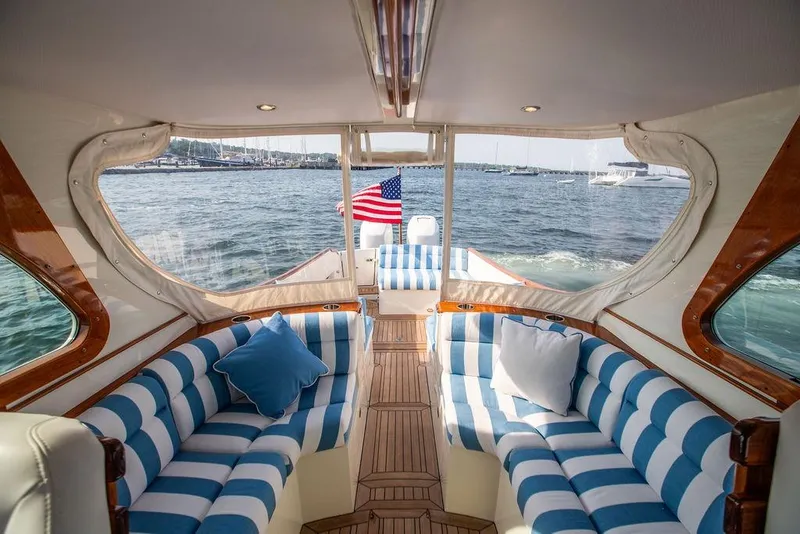 Slide: The Image of Luxurious 2022 Hinckley 35 yacht interior with striped seating and scenic ocean view. - 18