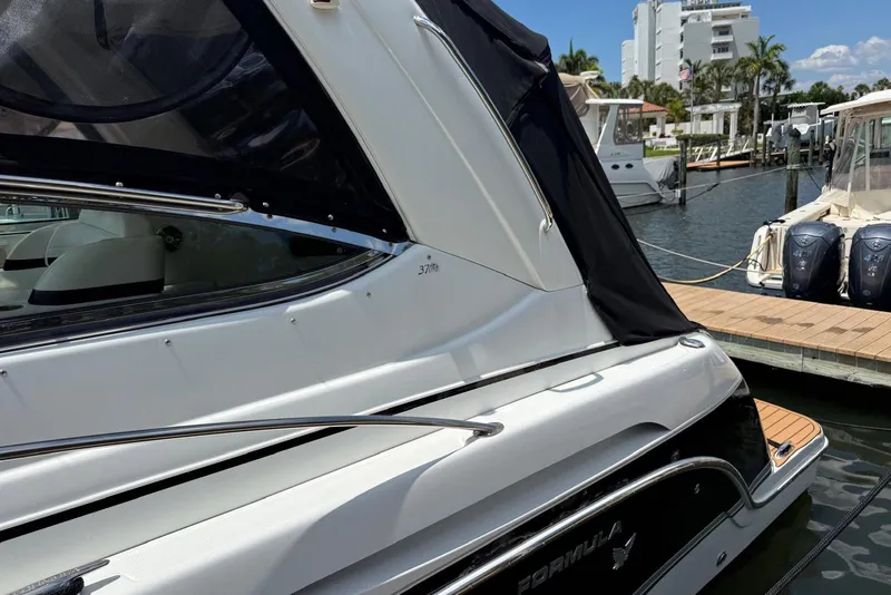 Slide: The Image of 2008 Formula 37 Performance Cruiser docked at marina, featuring sleek design and covered cockpit. - 11
