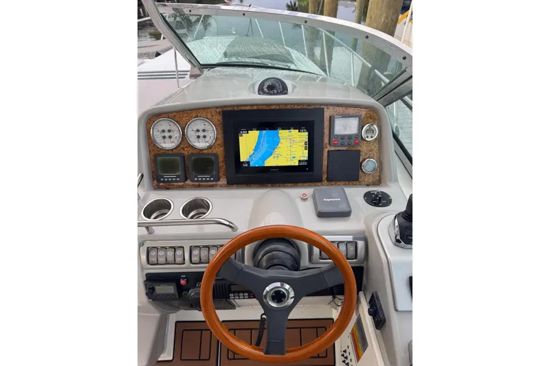 Slide: The Image of 2008 Formula 37 Performance Cruiser helm with navigation display and wooden steering wheel. - 15