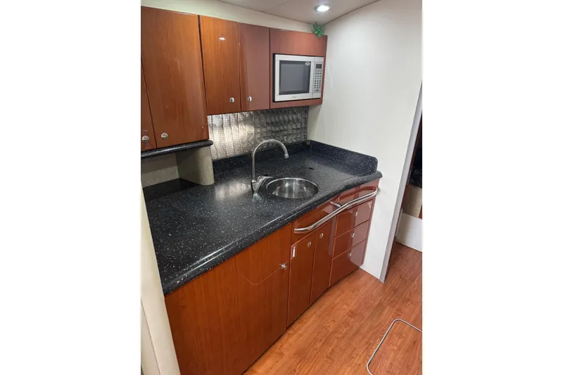 Slide: The Image of 2008 Formula 37 Performance Cruiser kitchen with wood cabinets and modern appliances. - 31