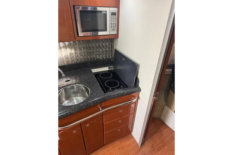 Slide: The Image of 2008 Formula 37 Performance Cruiser kitchen with microwave, stovetop, and sink. - 33