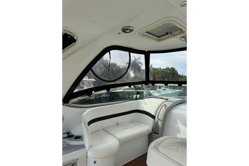 Slide: The Image of Interior of a 2008 Formula 37 Performance Cruiser with white seating and window view. - 46