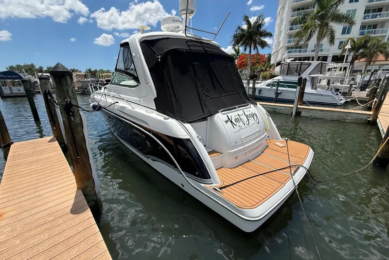 Slide: The Image of 2008 Formula 37 Performance Cruiser docked at marina under blue sky. - 8