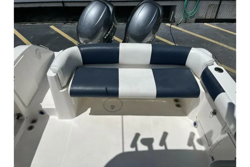 Slide: The Image of 2006 Century 2400 Walk-Around boat interior with striped seating and dual Yamaha engines. - 10
