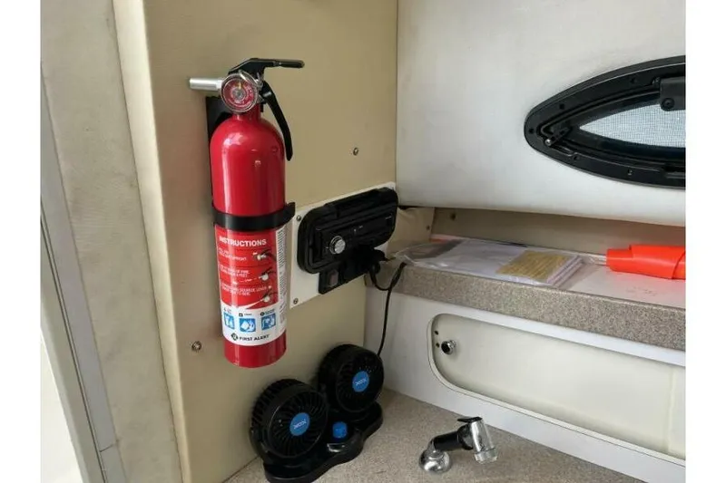 Slide: The Image of Interior of a 2006 Century 2400 Walk-Around boat with fire extinguisher and accessories. - 11