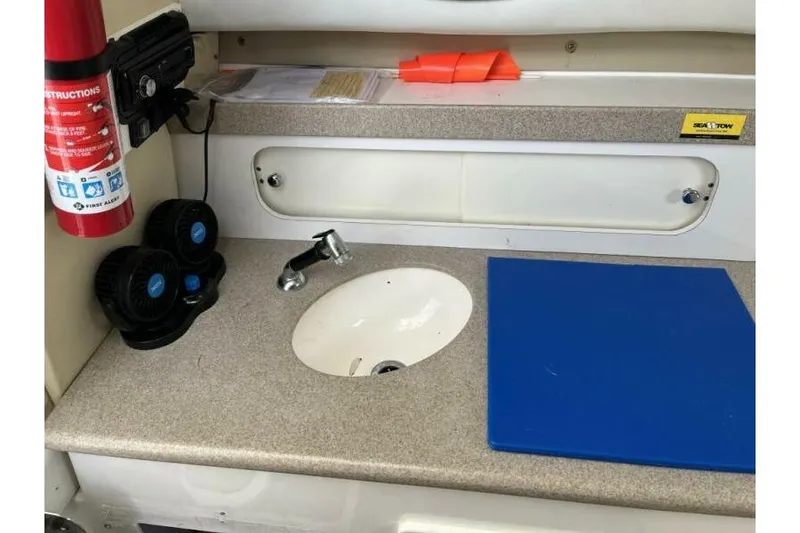 Slide: The Image of Interior of a 2006 Century 2400 Walk-Around boat with sink and countertop. - 12