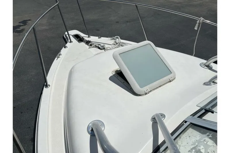 Slide: The Image of Bow view of 2006 Century 2400 Walk-Around boat with hatch and railing. - 15
