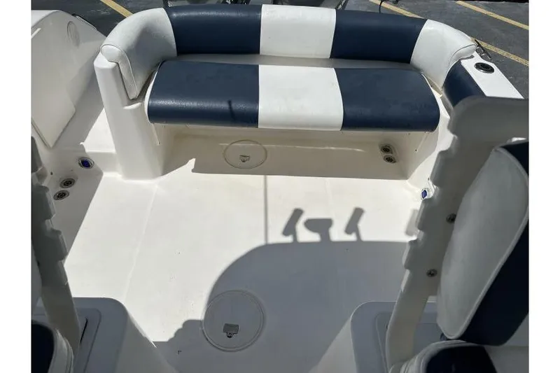 Slide: The Image of 2006 Century 2400 Walk-Around boat interior with blue and white seating. - 16
