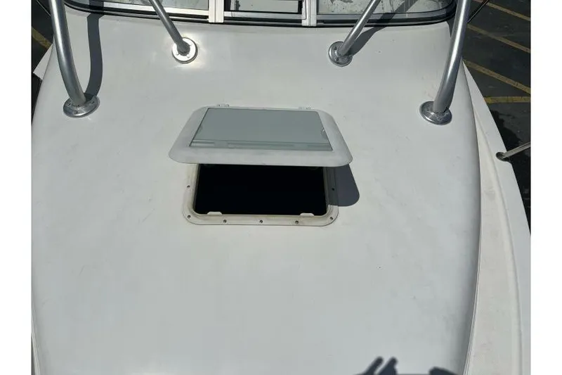 Slide: The Image of 2006 Century 2400 Walk-Around boat deck with open hatch and metal railings. - 17
