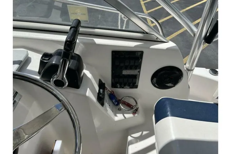 Slide: The Image of 2006 Century 2400 Walk-Around boat dashboard with steering wheel and control panel. - 6
