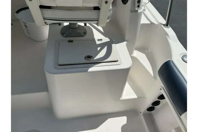 Slide: The Image of 2006 Century 2400 Walk-Around boat interior with seating and storage compartment. - 8