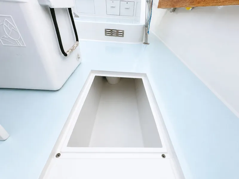 Slide: The Image of The image shows a boat interior with an open storage compartment in the floor. - 25