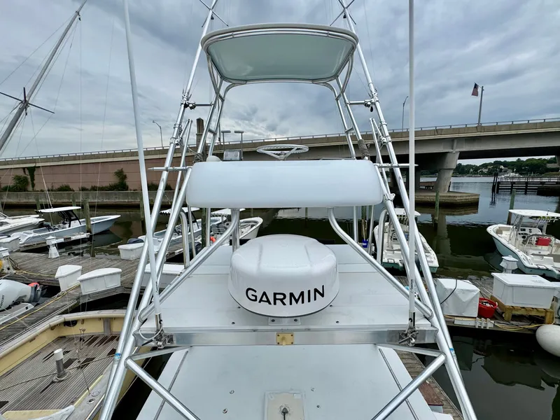 Slide: The Image of A 1992 L&H 33 boat with Garmin equipment, docked in a marina. - 10