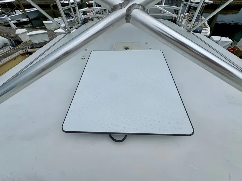 Slide: The Image of A 1992 L&H 33 boat with a white deck and metal railing. - 11
