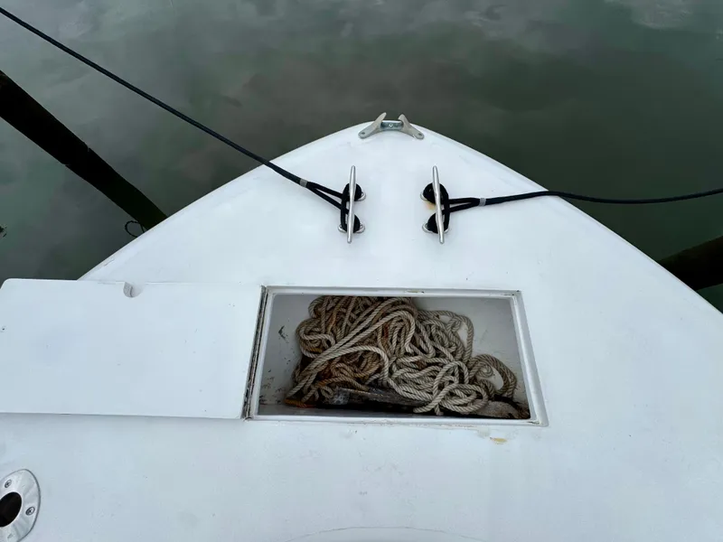 Slide: The Image of The image shows the bow of a boat with ropes stored in a compartment. - 13