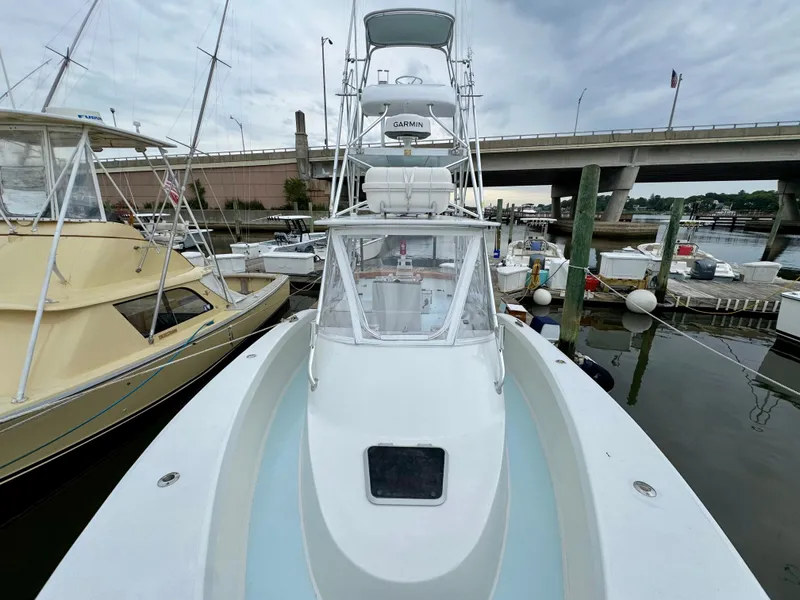 Slide: The Image of A 1992 L&H 33 boat docked in a harbor, surrounded by other boats. - 14
