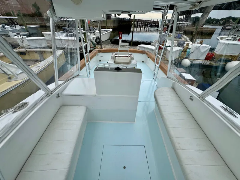 Slide: The Image of Interior view of a 1992 L&H 33 boat with white benches and clear windows. - 18