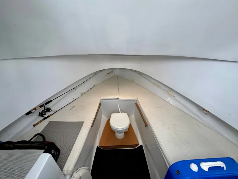 Slide: The Image of Boat interior with a toilet and fishing rods. - 21