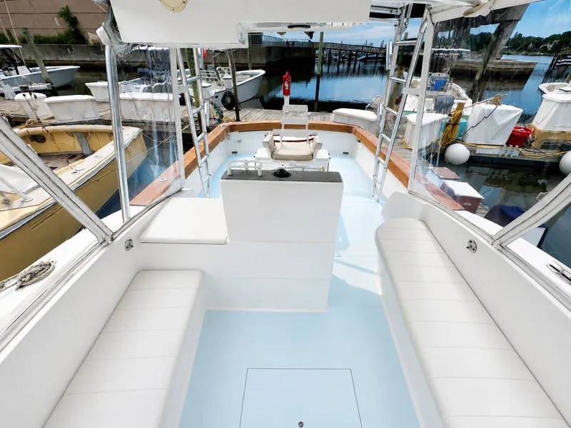 Slide: The Image of The image shows the cockpit of a 1992 L&H 33 boat docked at a marina. - 18