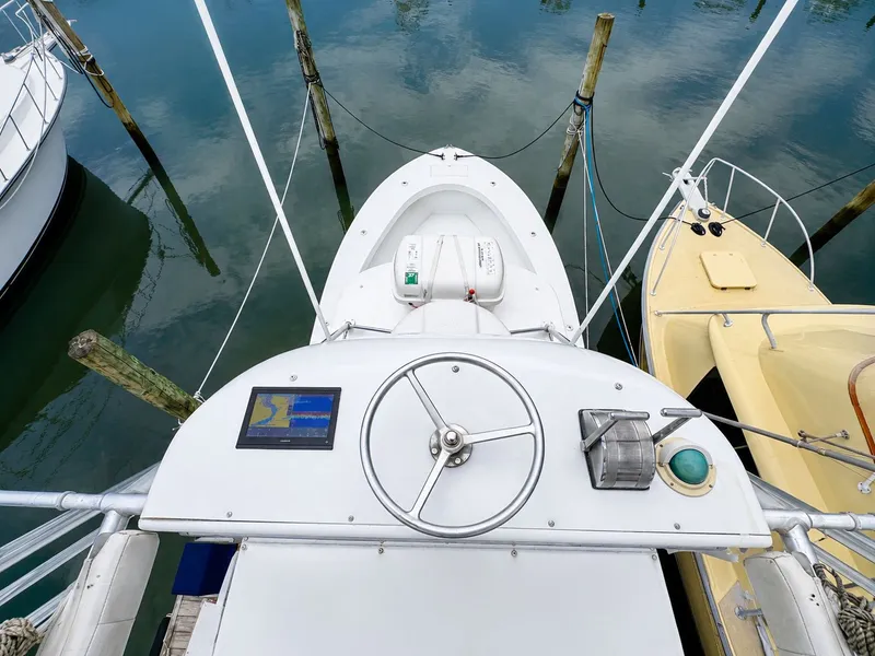 Slide: The Image of A 1992 L&H 33 boat docked. View of the helm and instruments. - 7
