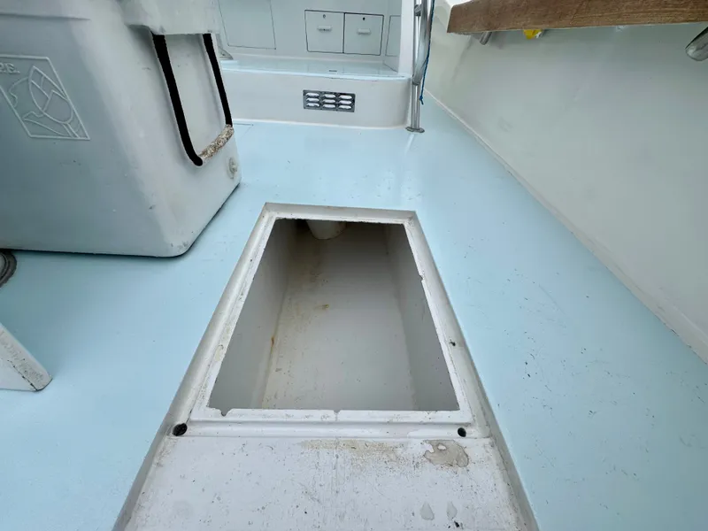 Slide: The Image of The image shows the floor of a boat with an open storage compartment. - 25
