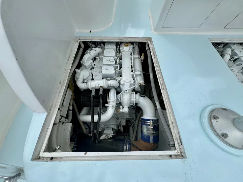 Slide: The Image of An engine compartment with a white engine inside a boat. - 27