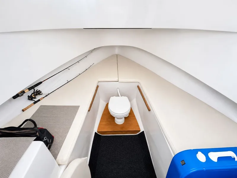 Slide: The Image of Interior of a 1992 L&H 33 with a toilet and fishing rods. - 21