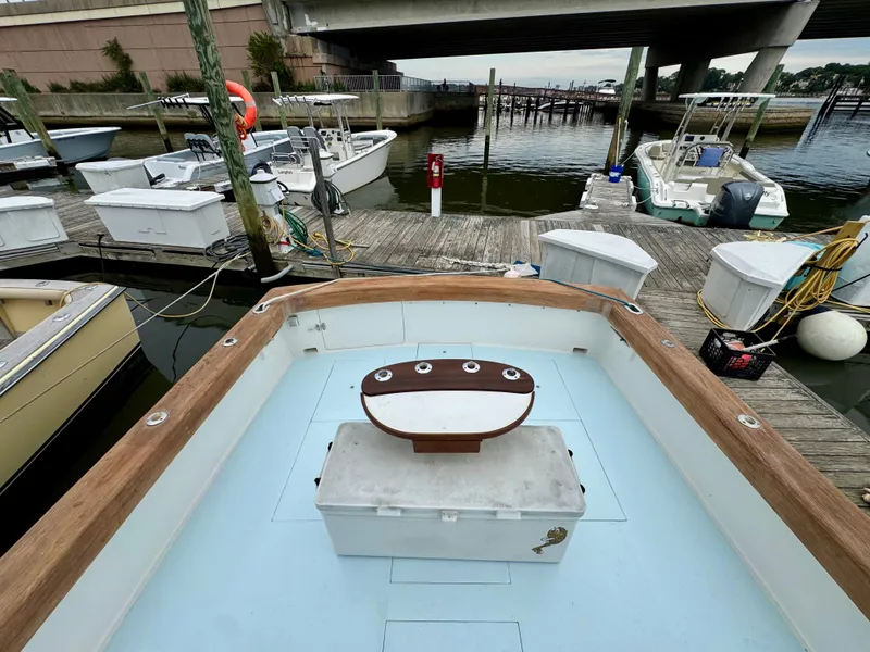 Slide: The Image of The 1992 L&H 33 boat is docked alongside other boats near a bridge. - 32