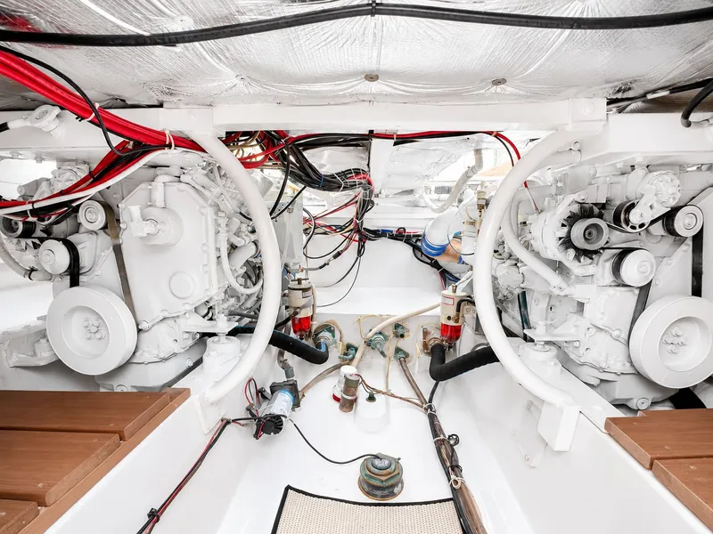 Slide: The Image of Engine room of a 1992 L&H 33 boat with two large engines and wiring. - 31