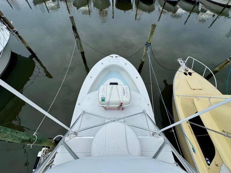 Slide: The Image of A 1992 L&H 33 boat is docked in a calm harbor, surrounded by other boats. - 9