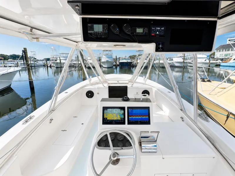 Slide: The Image of The image shows the cockpit of a 1992 L&H 33 boat with modern electronics. - 17