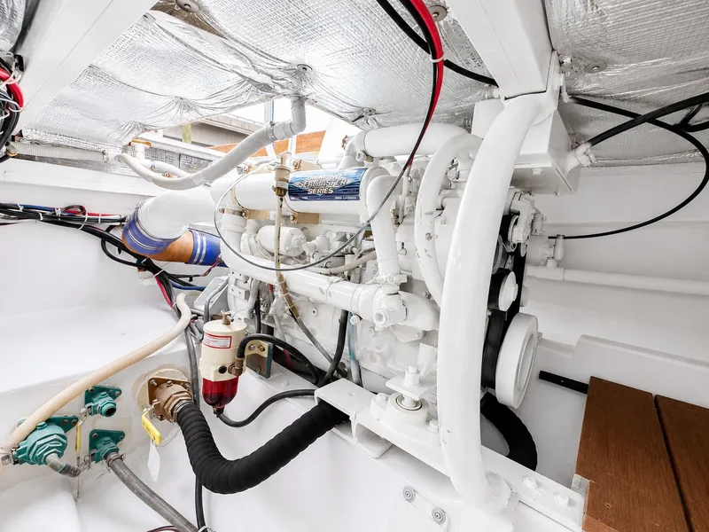 Slide: The Image of The engine room of a 1992 L&H 33 boat shows a well-maintained engine and wiring. - 30