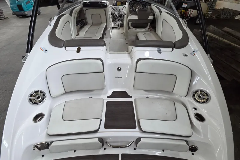 Slide: The Image of 2013 Yamaha 242 Limited S boat interior with white seating and modern design. - 14