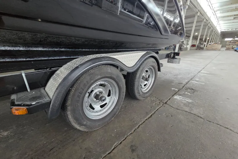 Slide: The Image of Trailer of a 2013 Yamaha 242 Limited S boat in a warehouse setting. - 18