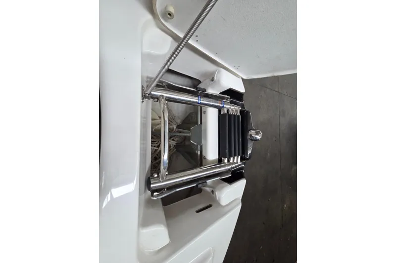 Slide: The Image of 2013 Yamaha 242 Limited S boat ladder, stainless steel, folded on white deck. - 21