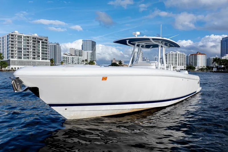The Image of 2021 Intrepid boat on water with city skyline in background. - 0