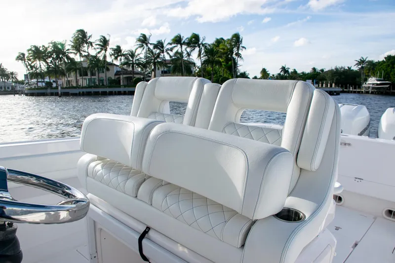 Slide: The Image of Luxurious white seating on a 2021 Intrepid boat, with scenic waterfront view. - 25