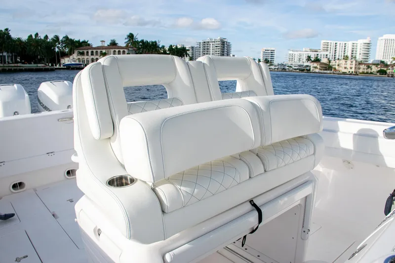 Slide: The Image of Luxury white seating on a 2021 Intrepid boat, with waterfront cityscape in the background. - 24