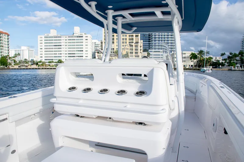 Slide: The Image of 2021 Intrepid boat with sleek design, docked near urban waterfront buildings. - 22