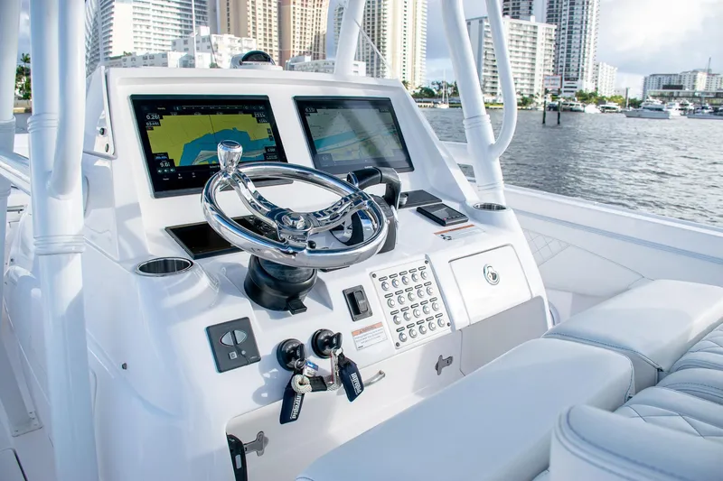 Slide: The Image of 2021 Intrepid boat helm with dual navigation screens and sleek steering wheel. - 28