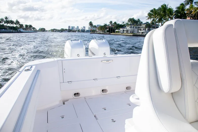 Slide: The Image of 2021 Intrepid boat with dual engines cruising on a scenic waterway. - 15