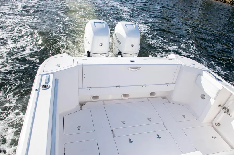 Slide: The Image of Intrepid 2021 boat with dual outboard motors cruising on water. - 16