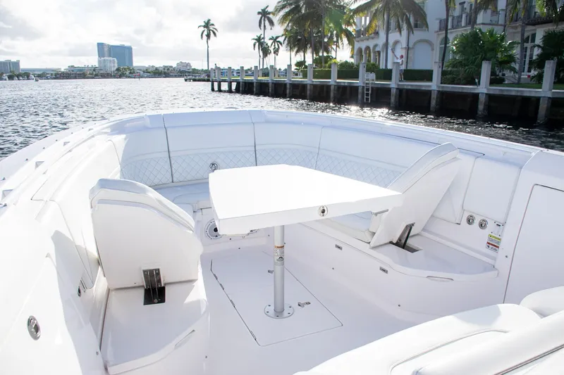 Slide: The Image of Luxurious 2021 Intrepid boat interior with white seating and table, dockside view. - 13