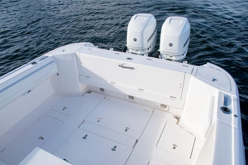 Slide: The Image of 2021 Intrepid boat with dual outboard motors on calm water. - 19