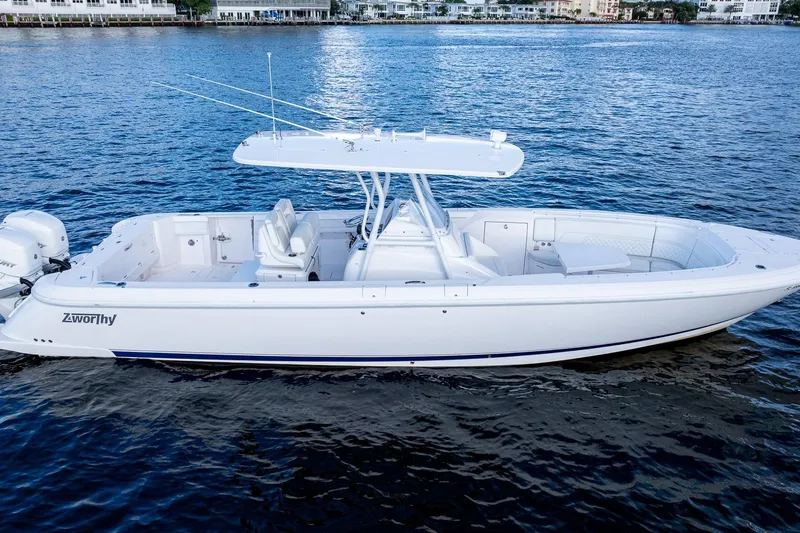 Slide: The Image of Intrepid 2021 boat on water, sleek white design, spacious deck, modern features. - 4