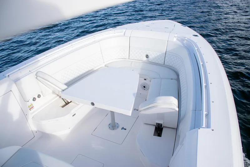 Slide: The Image of Luxurious 2021 Intrepid boat interior with white seating and table on open water. - 11