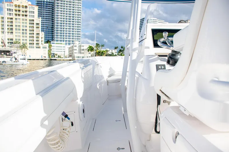 Slide: The Image of 2021 Intrepid boat interior with modern controls, docked near waterfront buildings. - 32